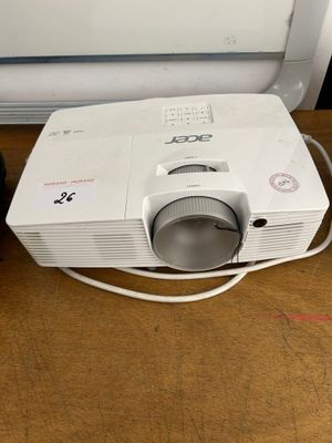 a small projector sitting on a table next to a laptop
