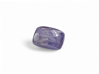 a close up of a purple sapphire stone on a white surface