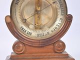 a clock that is on top of a wooden stand