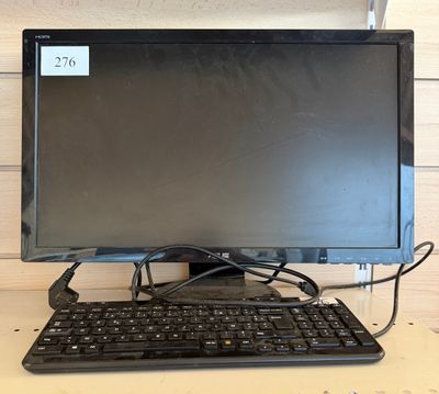 a computer monitor with a keyboard and mouse on a desk