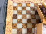 a chess board sitting on a table next to a box