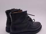 a pair of black leather boots on a white background
