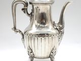 an antique silver tea pot with a handle on a white background