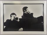 black and white photograph of a man taking a picture of himself with a camera