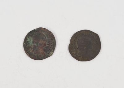 two ancient coins, one of which is a roman coin and the other of which is a roman coin
