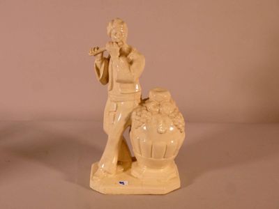 a figurine of a man with a flute in his hand