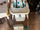 a baby high chair that is sitting on the floor