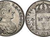 a silver coin with a crown on top of it