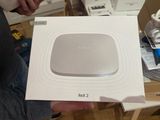 someone is holding a box with a white box on top of it