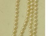un gros plan d'un collier de perles muni d'une étiquette
