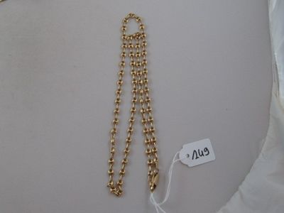 gold plated necklace with a chain and a tag attached to it