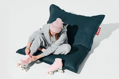 the girl is sitting on the floor with her skates