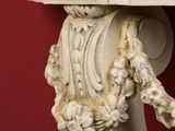 a close up of a decorative object on a red wall