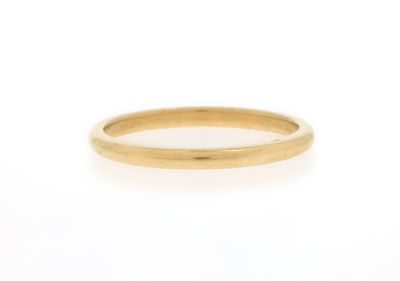 a close up of a gold ring on a white background