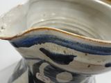 a blue and white vase sitting on top of a table