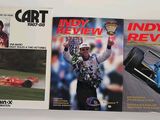 two books of indy racing on display on a white surface
