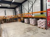 un grand entrepôt rempli de palettes et de cartons de denrées alimentaires