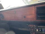 a dashboard of a car with a wooden panel and a radio