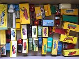 a cardboard box filled with assorted toy cars and trucks