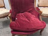 three chairs with a red cushion are sitting in a row next to each other