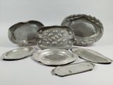 several pieces of silverware sitting on top of a white surface