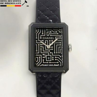 a black watch with a pattern on the face of it