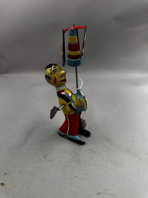 toy figurine of a fireman with a fire hydrant in his hand