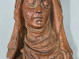 carved wooden statue of a woman with a veil on her head