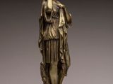 an image of a bronze statue of a woman holding a book