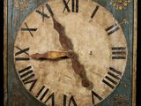 a clock with roman numerals on the face of it