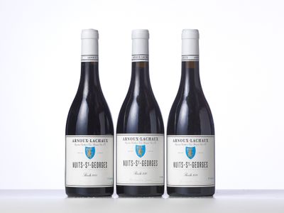three bottles of wine sitting on top of a table next to each other