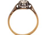 a close up of an antique diamond ring on a white background