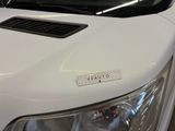 a close up of the hood of a white truck