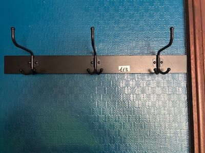a picture of a coat rack on a blue wall