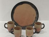 three coffee cups and a plate on a white surface