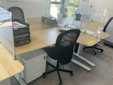 a desk with two chairs and a computer on it