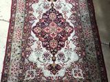 an oriental rug on the floor in a room with concrete flooring