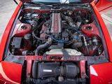 a red car with its hood open and the engine in it