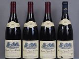 four bottles of wine are lined up on a table