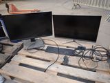 two computer monitors and a keyboard on a pallet