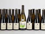 six bouteilles de vin sont alignées sur une table