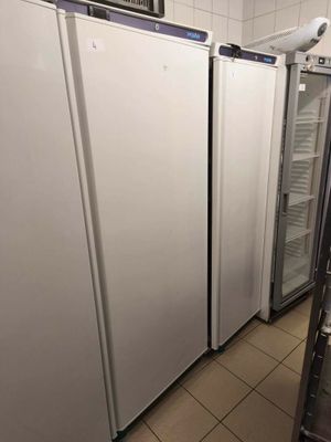 three refrigerators in a row in a kitchen