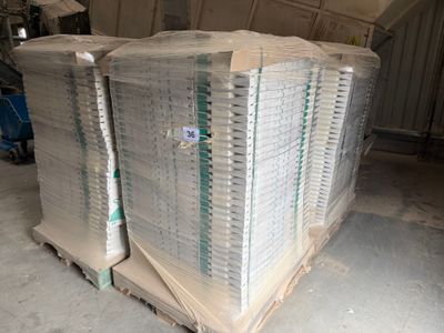 a large stack of paper on a pallet in a warehouse