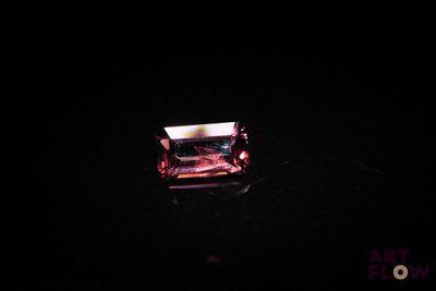 an image of a pink diamond in the dark