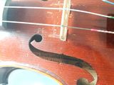 a close up of a violin that is on a table