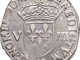 a silver coin with a crown on top of it