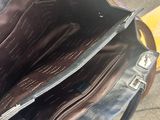 a black purse that is sitting on a table