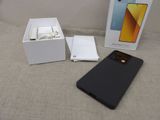 an image of a box with a phone in it sitting on a bed