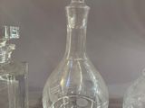 three glass bottles sitting on a table next to each other