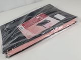 a bag of black and pink fabric on a table